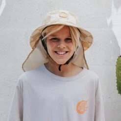 Plow Surf Co. | Beach Beige | Plow Surf Hat | Surfing Hat | Beach + Water Activity Headwear | -FCS Store Buy Plow Surf Co Beach Beige Surfing Hat With Chin Strap Kids 50484.1692944959