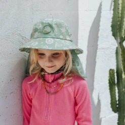 Plow Surf Co. | Gumnut Green Floral | Plow Surf Hat | Surfing Hat | Beach + Water Activity Headwear | -FCS Store Buy Plow Surf Co Gumnut Green Floral Surfing Hat With Chin Strap Kids 13081.1692943756